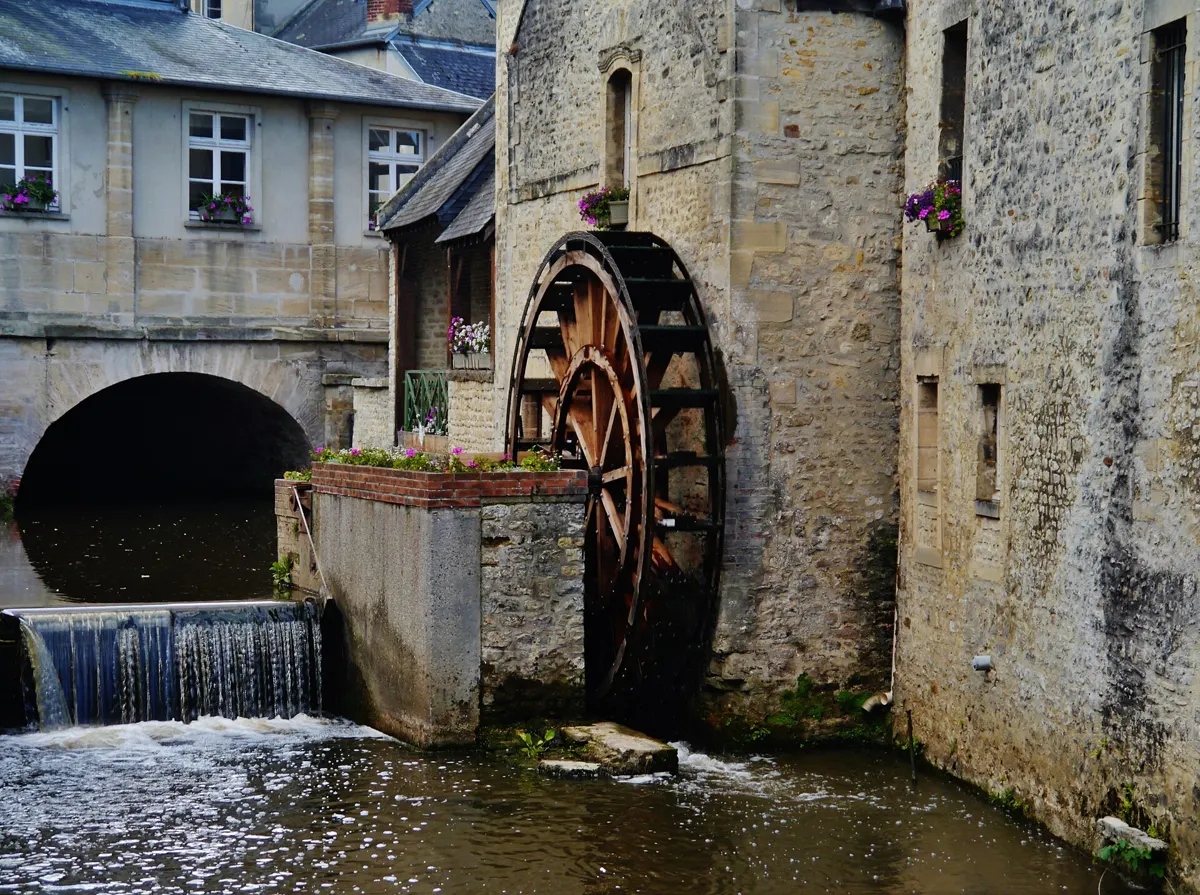Water wheel on the Aure river in Bayeux on a day trip from Paris to Normandy