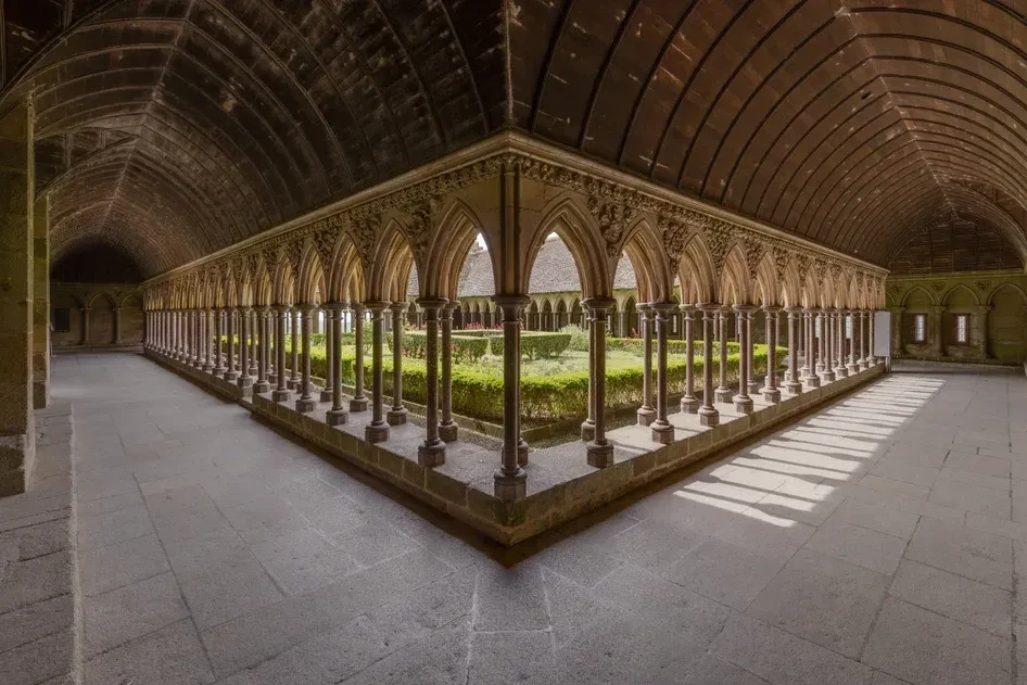 Arcaded cloister of Mont-Saint-Michel abbey, a highlight of a guided day tour from Paris