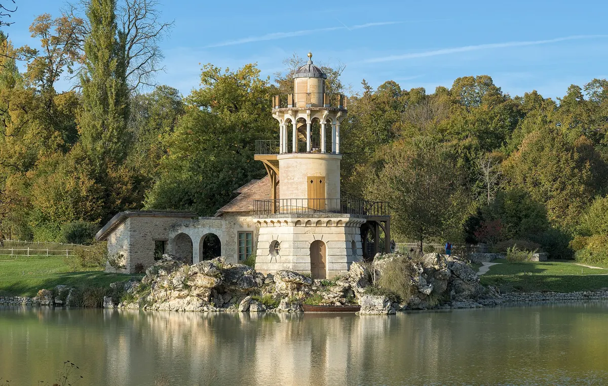 Marlborough Tower and pond at the Queen's Hamlet in Versailles on a day trip from Paris